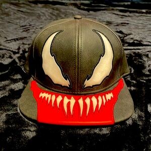 This hat is a adjustable snap back marvel venom hat, no damages are on the hat